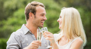 couple laughing and toasting with champagne