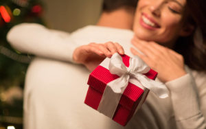 Couple hugging and exchanging gifts