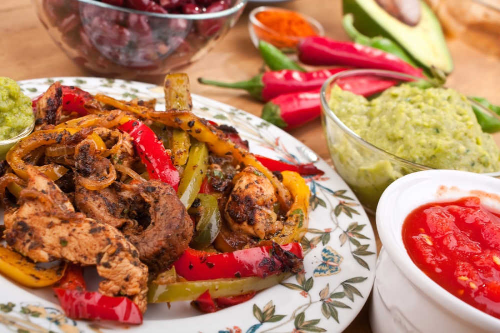 Tex-Mex food chicken fajitas with salsa and guacamole